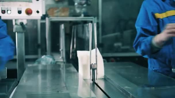 Factory workers are putting paper tissues on the conveyor — Stock Video