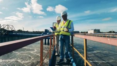 Atık su operatörleri bir atık su temizleme tesisinde su örneklerini inceliyor