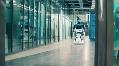 Robot ofis koridorunda ilerliyor.