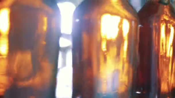Close up of moving bottles filled with alcoholic beverage — Stock Video