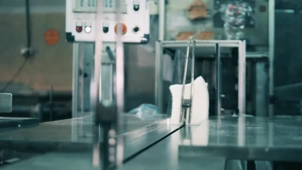 Facial tissues being placed onto a conveyor belt — Stock Video