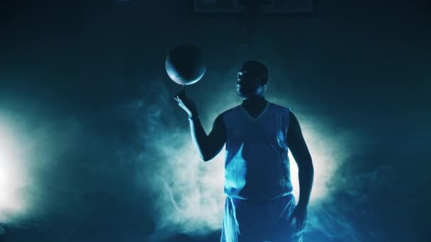 Hombre jugador está girando una pelota de baloncesto en su dedo — Vídeos de Stock