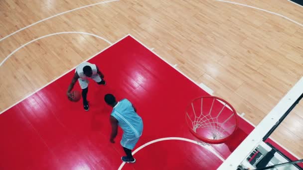 Basketballspieler im Dunkeln. Zwei afrikanische Männer wetteifern beim Basketballtraining — Stockvideo