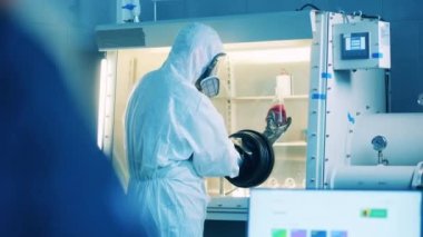 Vacuum cabinet with a scientist using it to analyze a probe