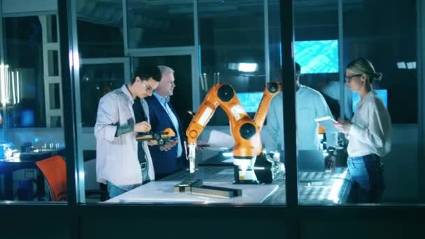 Researchers are working together on a robotics project. Professional engineers working with innovative equipment, teamwork concept. — Stock Video