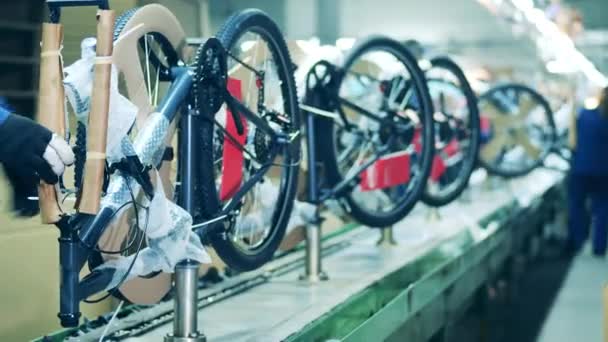 Packed up bicycle being taken from a production line — Stock Video