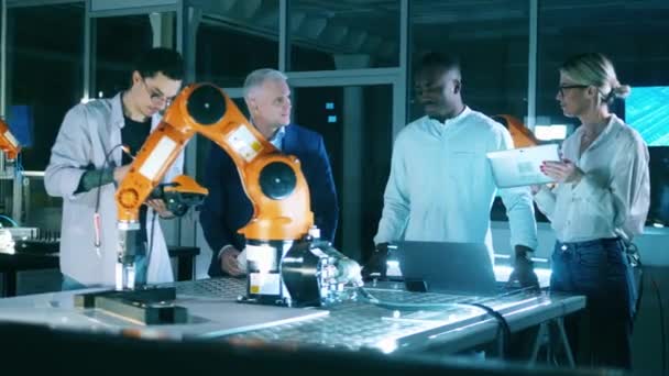 Team of science workers working with a robot in technology research laboratory. — Stockvideo