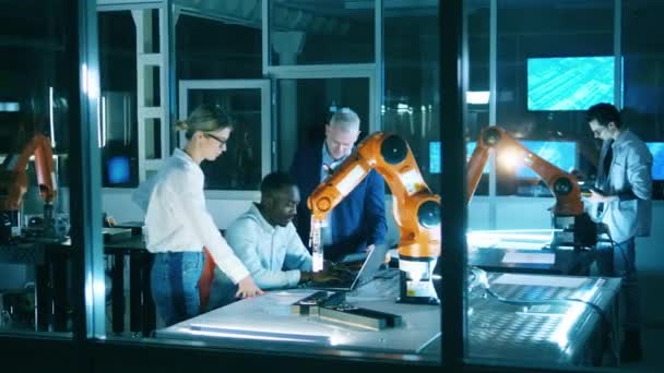 Group of science workers, developers work with robotic arm. — Stock videók