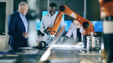 Team of science workers are studying a robotic device