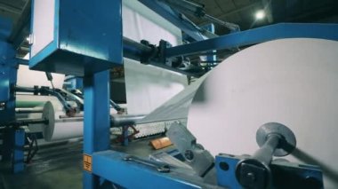Kağıt fabrikasında büyük bir kağıt dönüştürme makinesi.