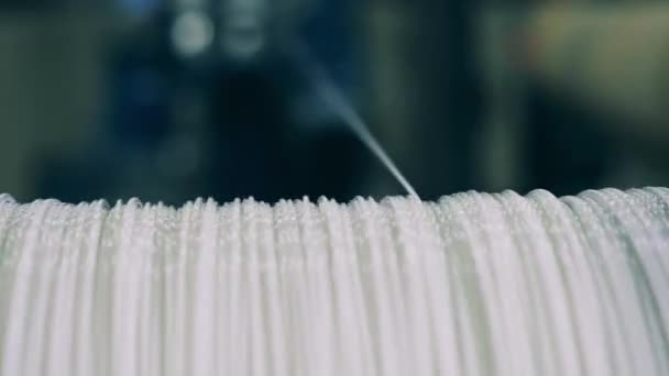 Kabel putih sangat tipis unwinding dari spool dalam close up — Stok Video