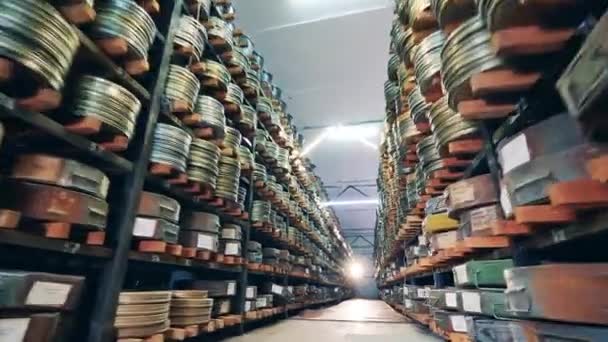 Pathway between the shelves of the cinema archive — Stock Video