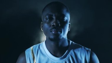 Afrikalı basketbolcu kameraya bakıyor.