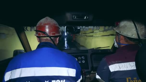 Two miners are driving through an underground tunnel — Stock Video