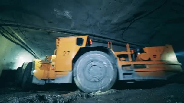 Underground tunnel with an industrial machine driving through it — Stock Video