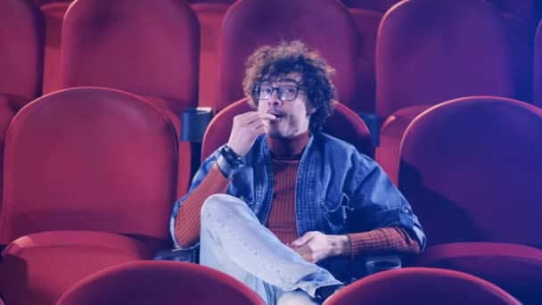 Cinema hall with a man laughing hard at the movie — Stock Video
