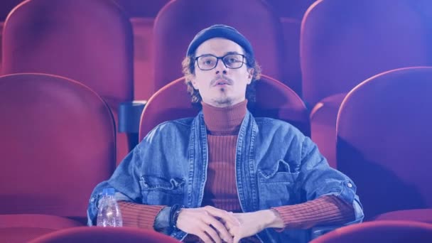 Un uomo è sempre teso mentre guarda un film al cinema — Video Stock