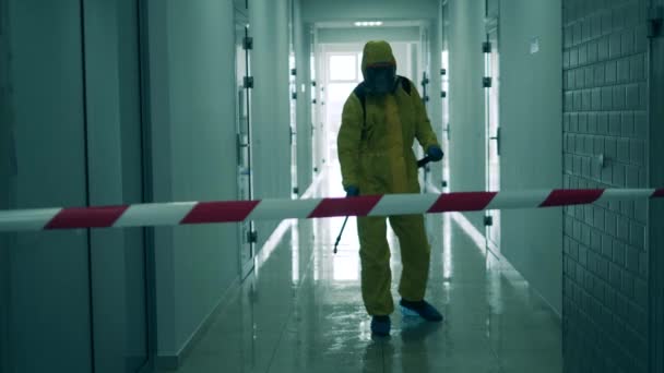 Un pasillo con una cinta de advertencia se está desinfectando. Desinfección, concepto de saneamiento. — Vídeos de Stock