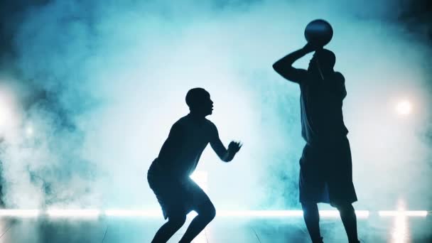 Slow motion of athletes practicing basketball in a room with smoke — Stock Video