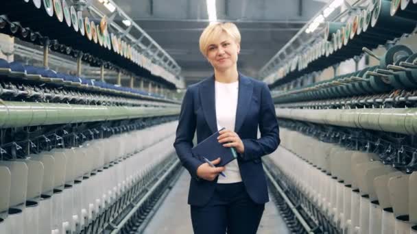 Бізнес-леді посміхається в текстильній фабриці одиниці — стокове відео