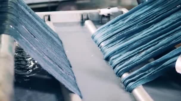 Yarn is getting washed by a factory mechanism. Textile production, textile industry, textile manufacture, textile manufacturing. — Stock Video