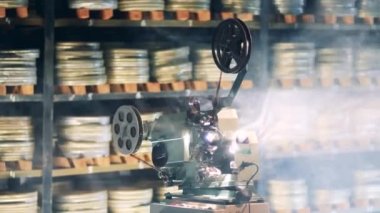 İş yerinde eski moda bir kaset projektörü olan bir film arşivi. Retro, antika teknoloji konsepti.