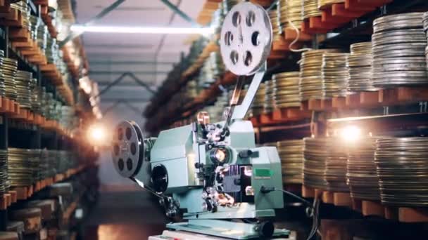 Old-fashioned projector is demonstrating a film. Retro, vintage technology concept. — Stock Video