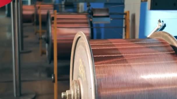 Rotating reels with copper wire on them — Stock Video