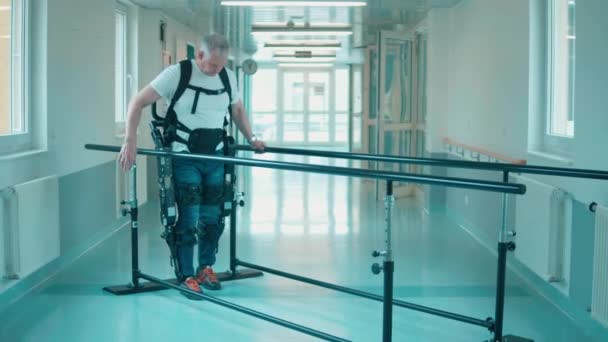 Hombre discapacitado está caminando en el exosuit por sí mismo — Vídeos de Stock