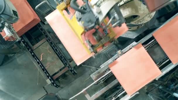 Top view of copper pieces getting transported by industrial robots — Stock Video