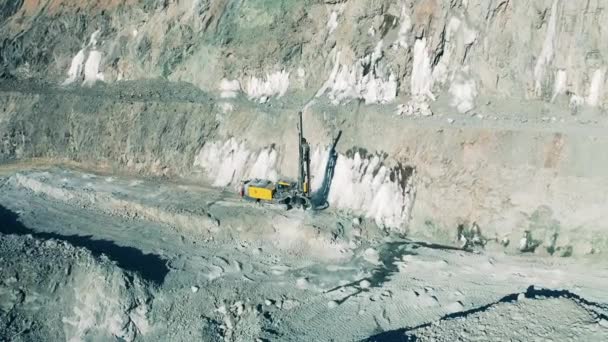 Quarry site with a drilling machine filmed from above — Stock Video