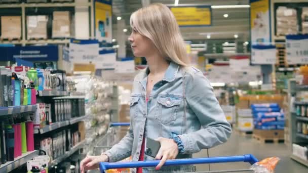 Blond woman is buying travel dishware in the store — Stock Video