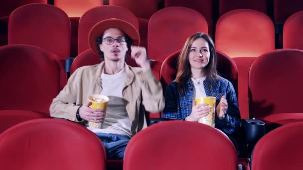 Facet obmacuje swoją dziewczynę w kinie. — Wideo stockowe