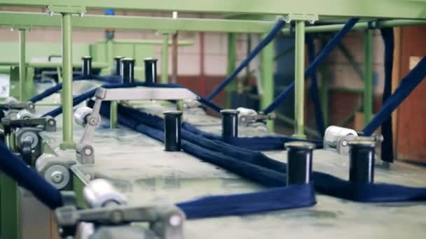 Blue yarn strings are getting straightened by a factory mechanism — Stock Video