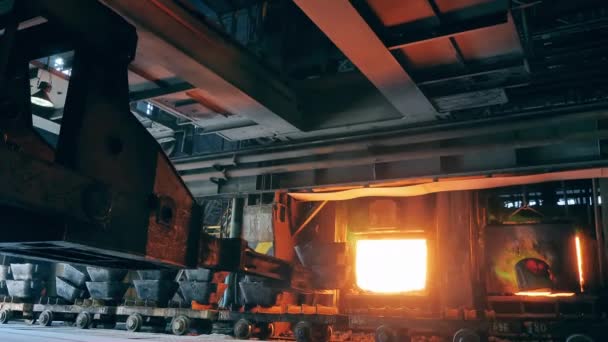 Foundry furnace with industrial mechanism loading metal into it — Stock Video