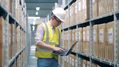 Depoda çalışan güvenlik görevlisi paketleri kaydediyor.