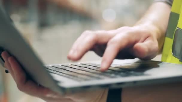 Close up of laptop keyboard with a male employee typing on it — Stok Video