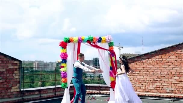 Man and woman, young people, happy married adult couple standing near wedding arch. — Stock Video