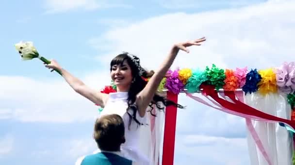 Man and woman, young people, happy married adult couple dancing near wedding arch. — Stock Video