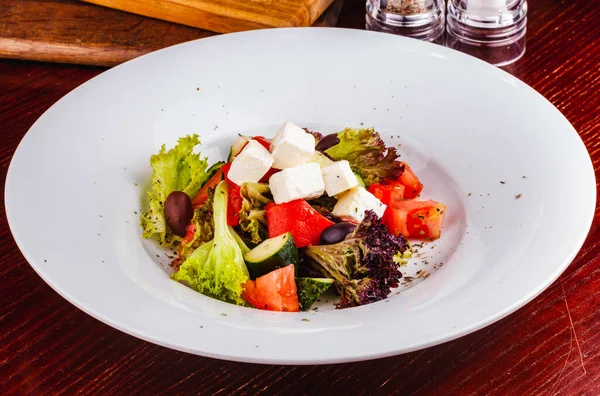 Görög Saláta Friss Zöldségekkel Feta Sajttal Fekete Olajbogyóval Fehér Tálcán — Stock Fotó