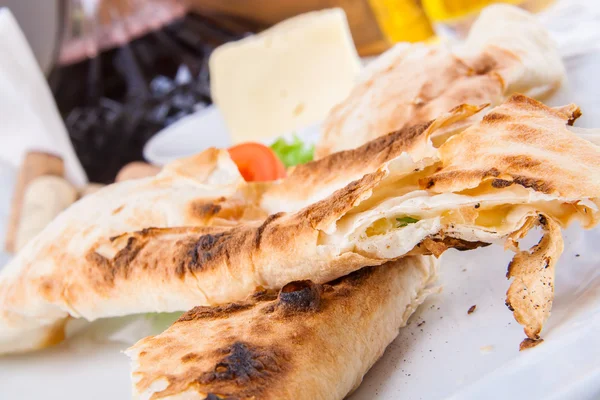Roasted rolls of bread lavash filled with cheese — Stock Photo, Image
