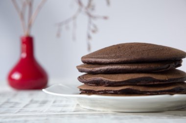Chocolate pancake on a light background clipart