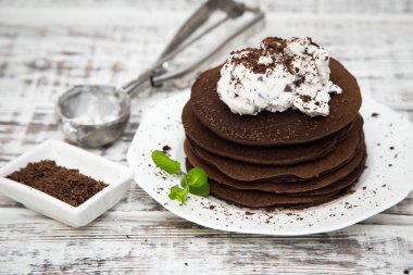 Chocolate pancake with icecream on a light background clipart