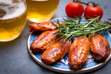 Kızarmış tavuk kanadı bira koyu gri arka plan üzerinde ile.