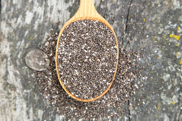 Nutritious chia seeds on a wooden spoon — Stock Photo, Image