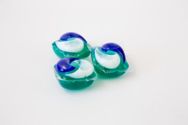 Beyaz bir arka plan üzerinde çamaşır deterjanı ile kapsül.