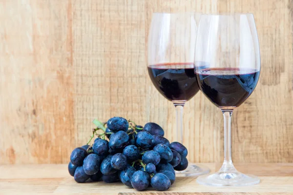 Fresh grape and red wine on the vintage table, selective focus