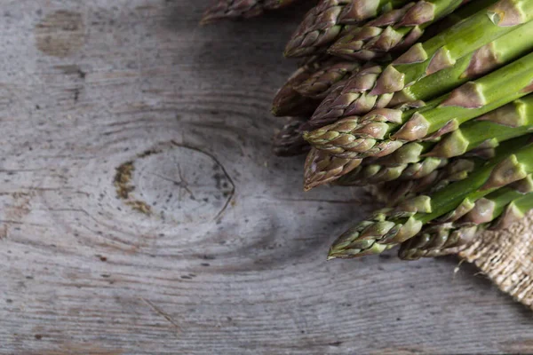 green Asparagus. Bunches of green asparagus on a grey wooden rustic background