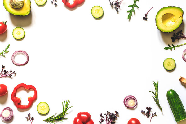 Creative layout of tomatoes, cucumbers, bell peppers, avocados and salads. flat lay. Food concept. place for your text.