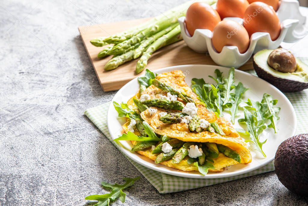 Gourmet Tasty Egg Omelette with Asparagus and soft Cheese. Asparagus. Fresh Asparagus with eggs.